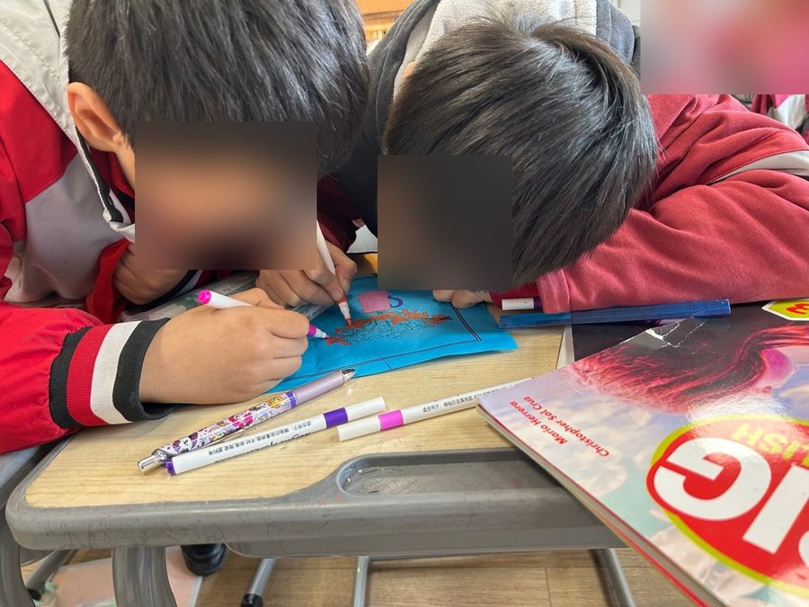 Two Grade 3 students working together on Women's Day cards