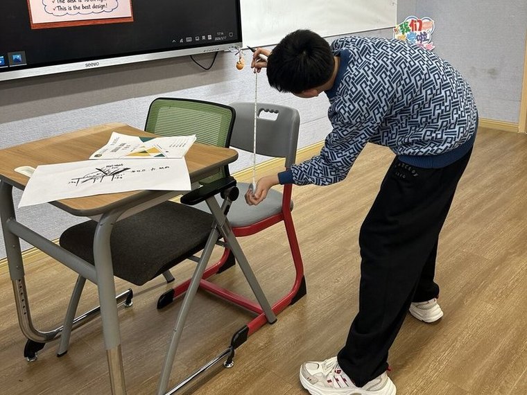 Student measuring desk and chair angles during the Perfect Desk inquiry