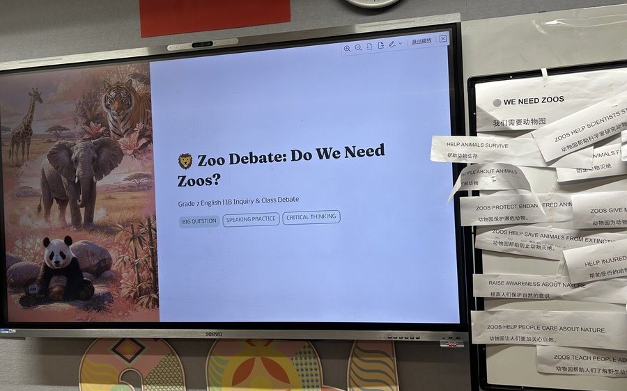 Grade 7 Zoo Debate lesson with student arguments displayed beside the screen